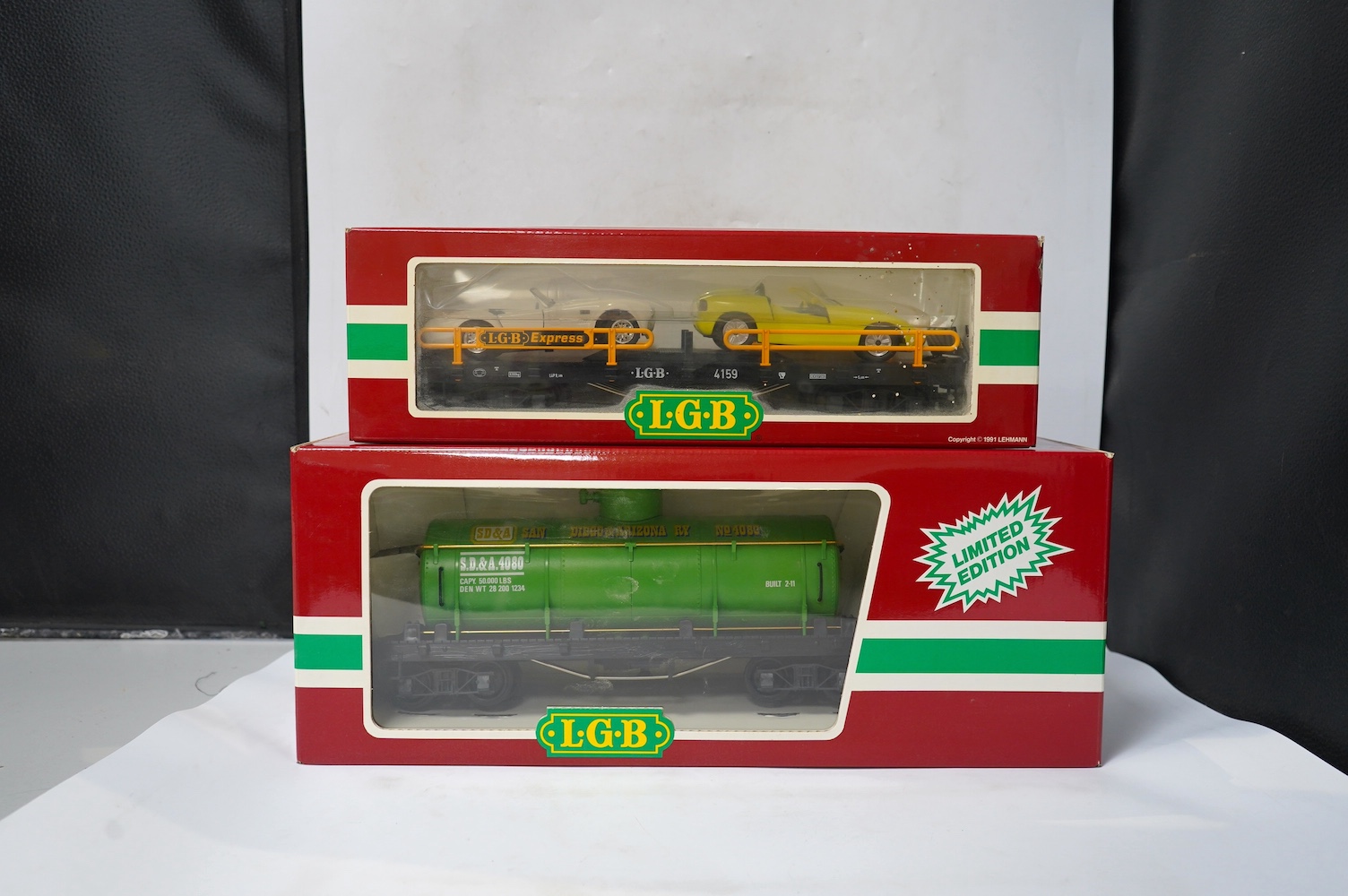 Four boxed Lehmann LGB G scale bogie rolling stock; a tanker (4080-Y 05), a car transporter (4159), And two Denver and Rio Grande Western Railway coaches (3081 and 4075). Condition - good.